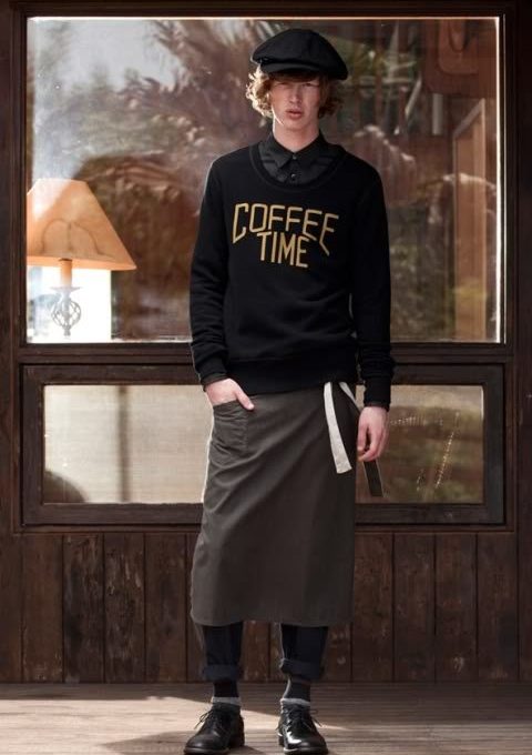 pánský černý svetr s nápisem, černé kalhoty a pracovní zástěra FACTOTUM